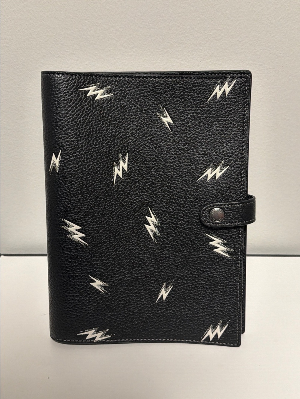 Coach Black pebbled leather with lightening bolts notebook